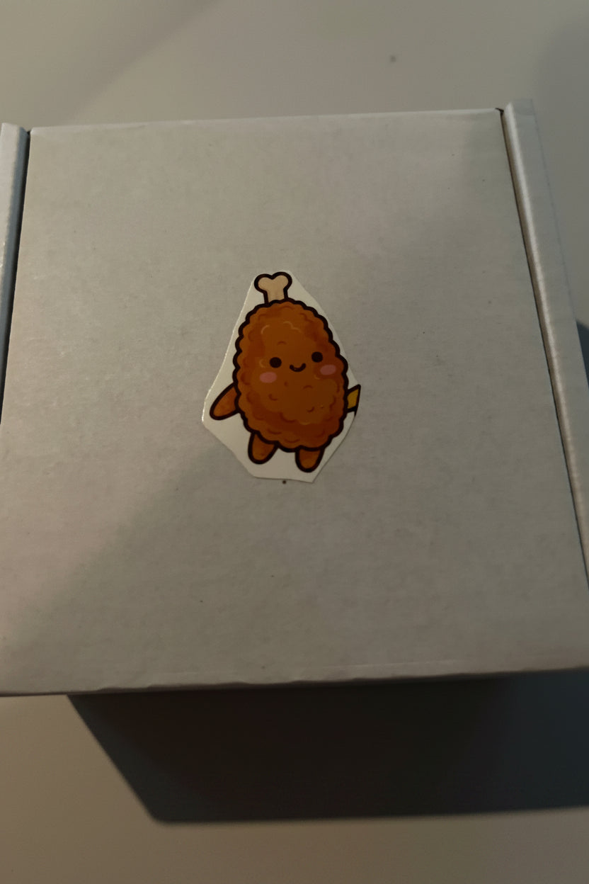 Sticker of a cartoonish roasted chicken on a plain background